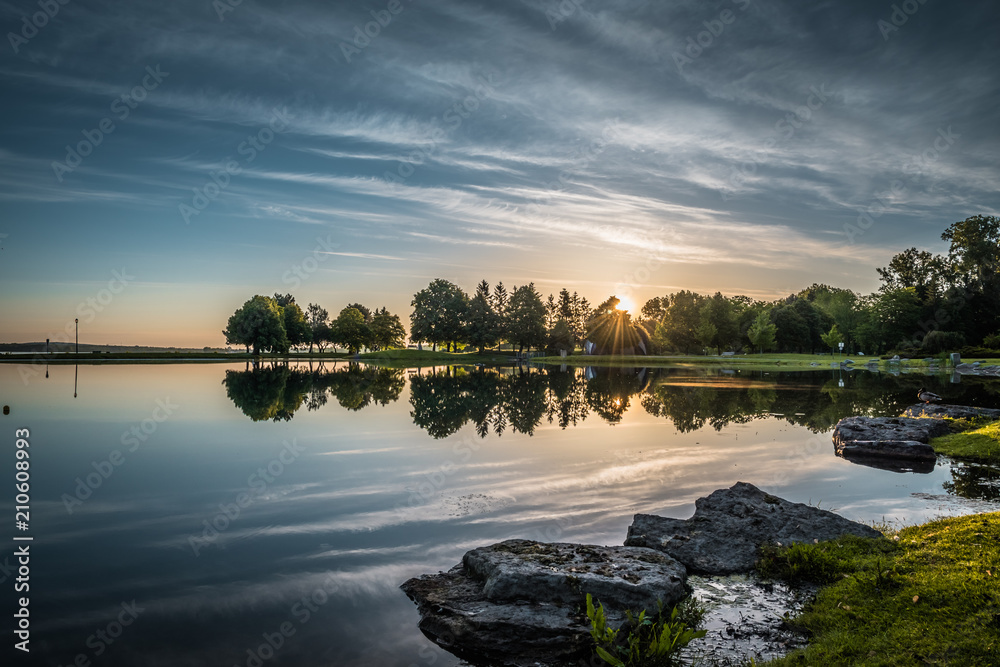 OTTAWA, ONTARIO / CANADA - JUNE 10 2018: TREES REFLECTION IN THE WATER IN THE MORNING.