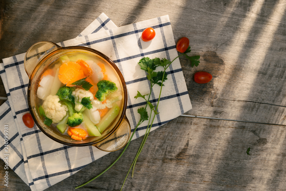 Assorted vegetables in glass pot on a napkin close up