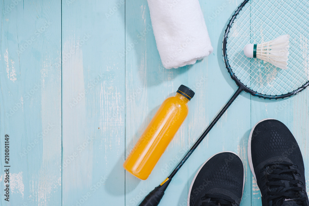 Sport equipment and footwear on wooden background