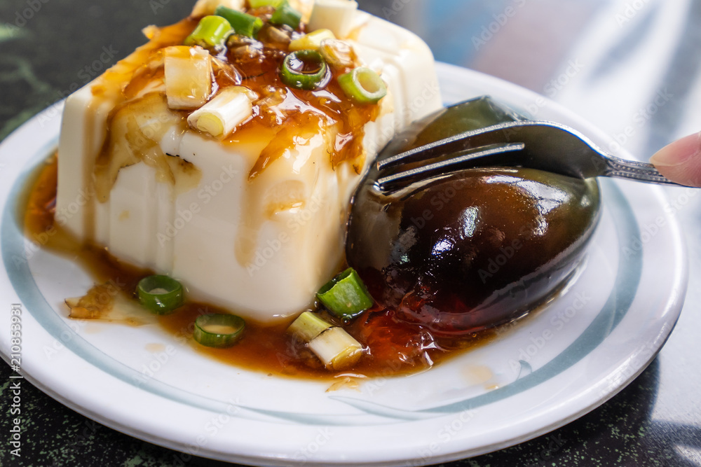 Taiwans distinctive famous snacks: thousand-year-old eggs tofu(pidan tofu) in a white plate on ston