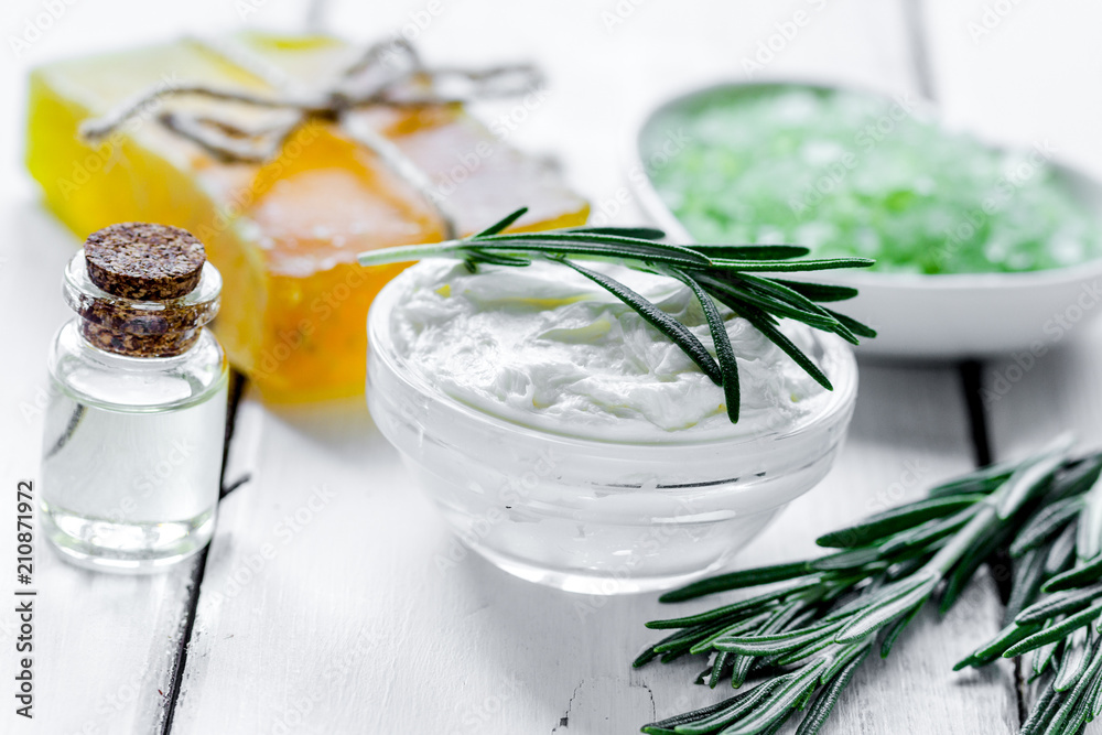 organic cosmetics with rosemary extract on wooden table backgrou