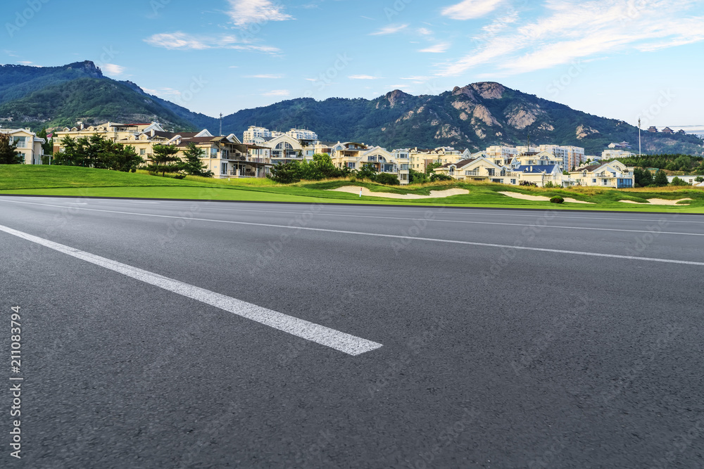 Asphalt road square and river hill under the blue sky