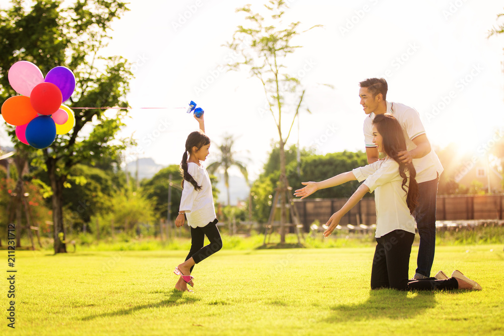 Asian family run and play in a garden