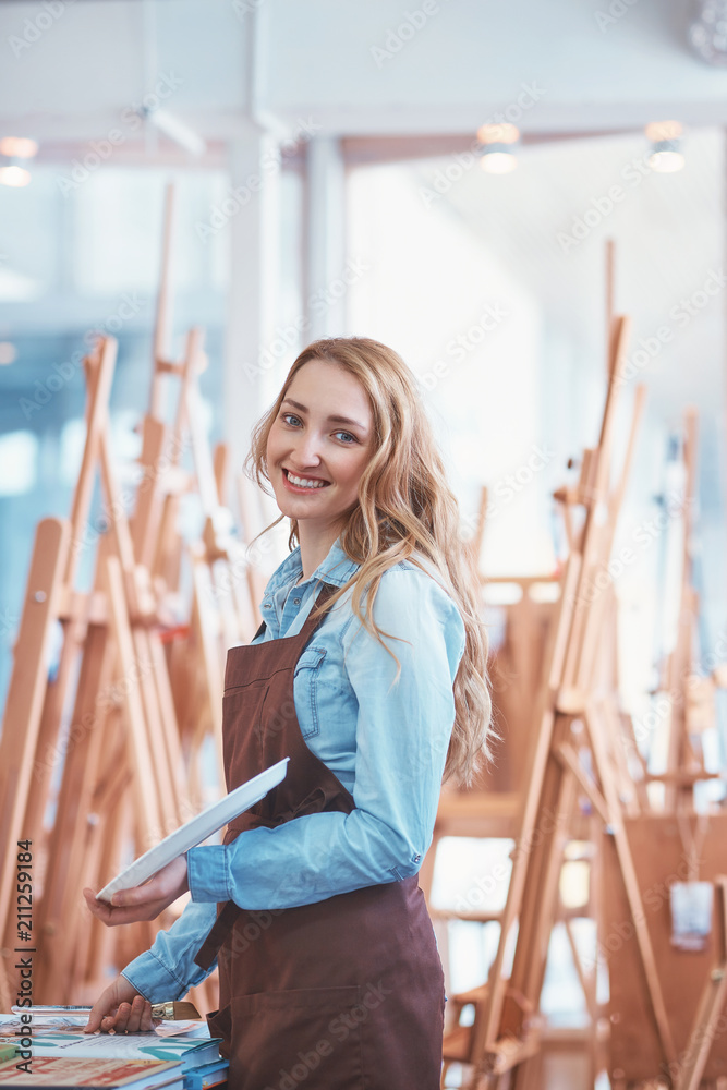 Young attractive artist in the art store