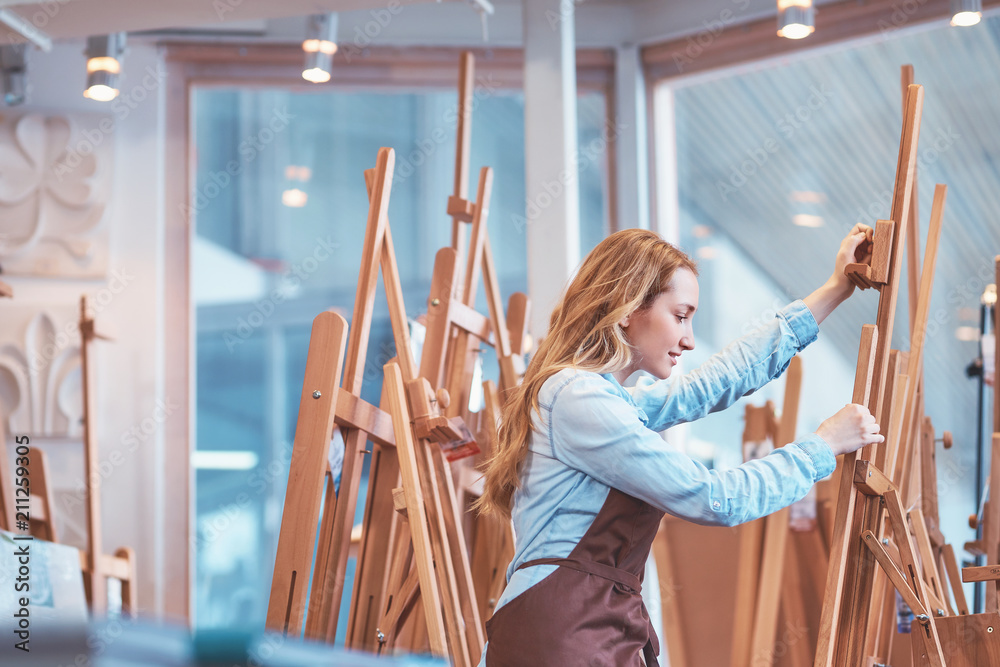 Young attractive artist at the easel