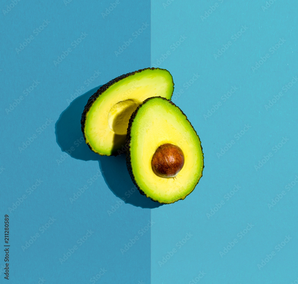 Fresh avocado on a blue background flat lay