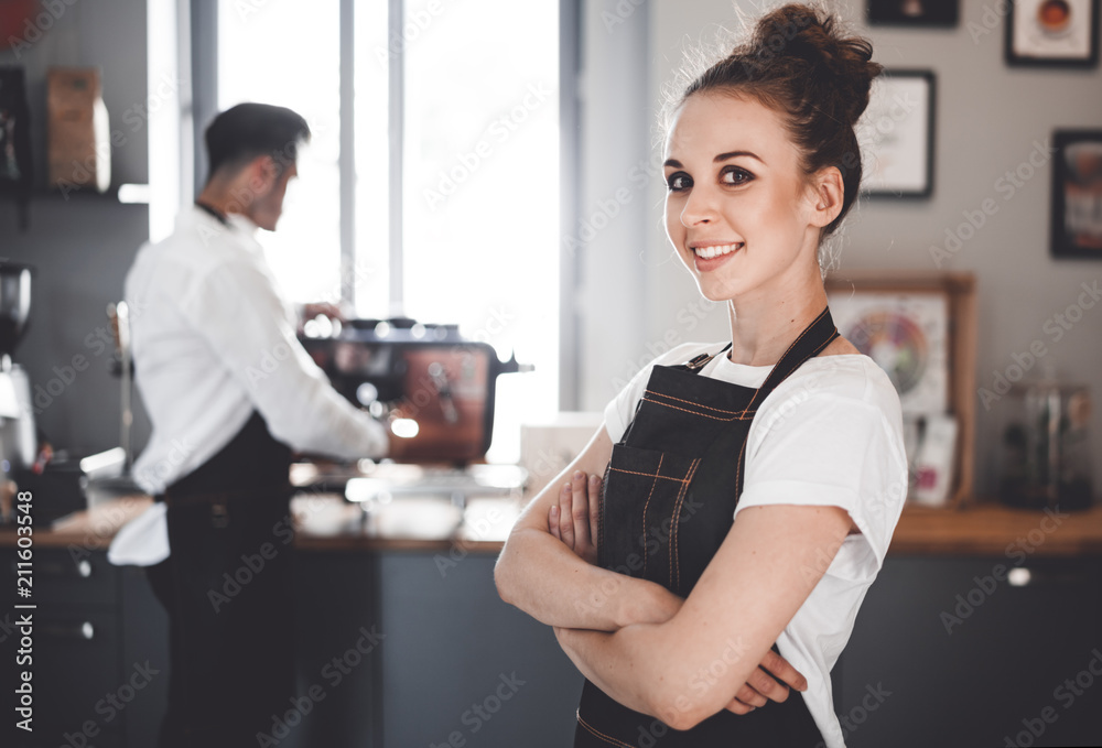 Smiling woman barista in apron, Coffee business owner