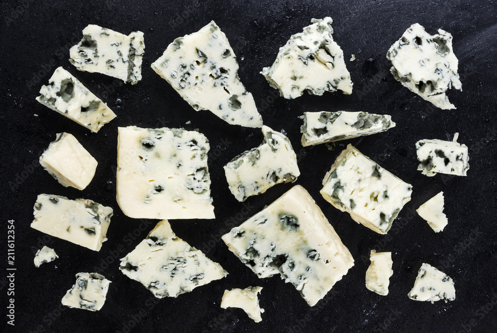 Danish blue cheese on dark background. Top view