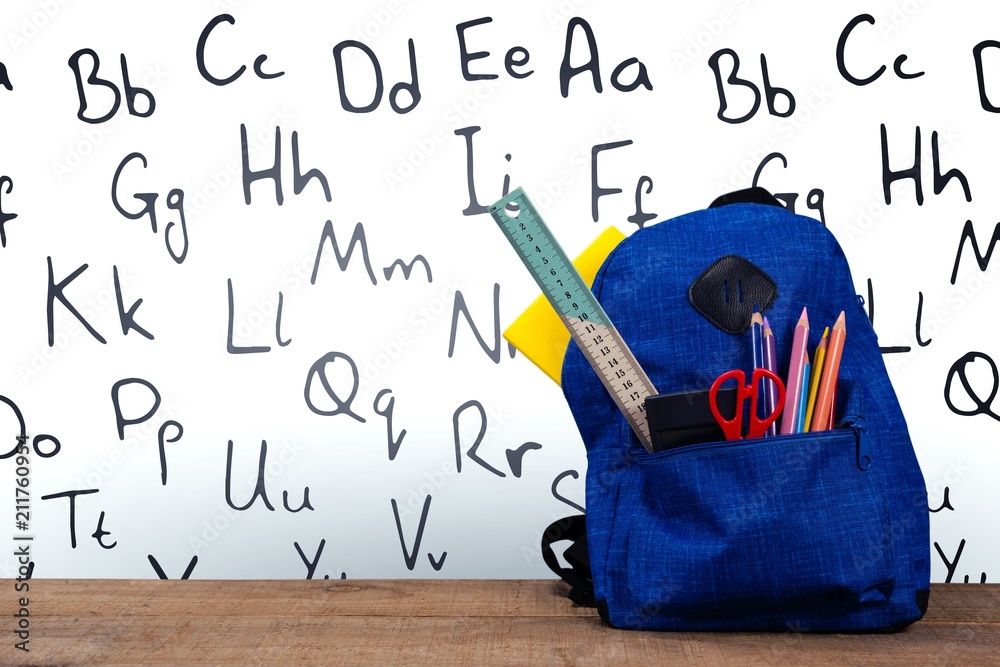 Schoolbag on wooden table