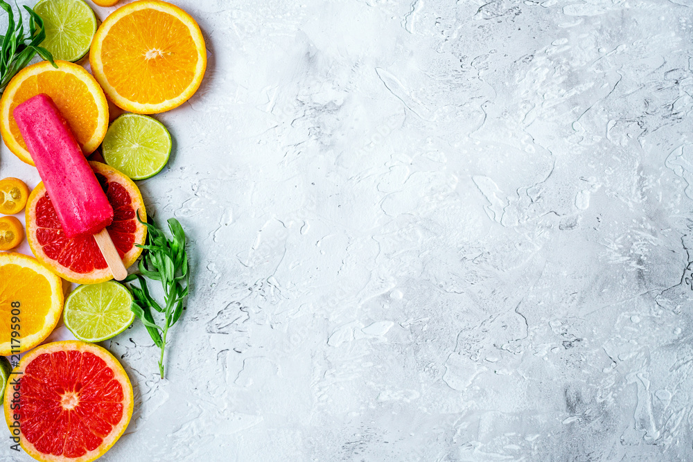 citrus popsicles with fruit slices on stone background top view 