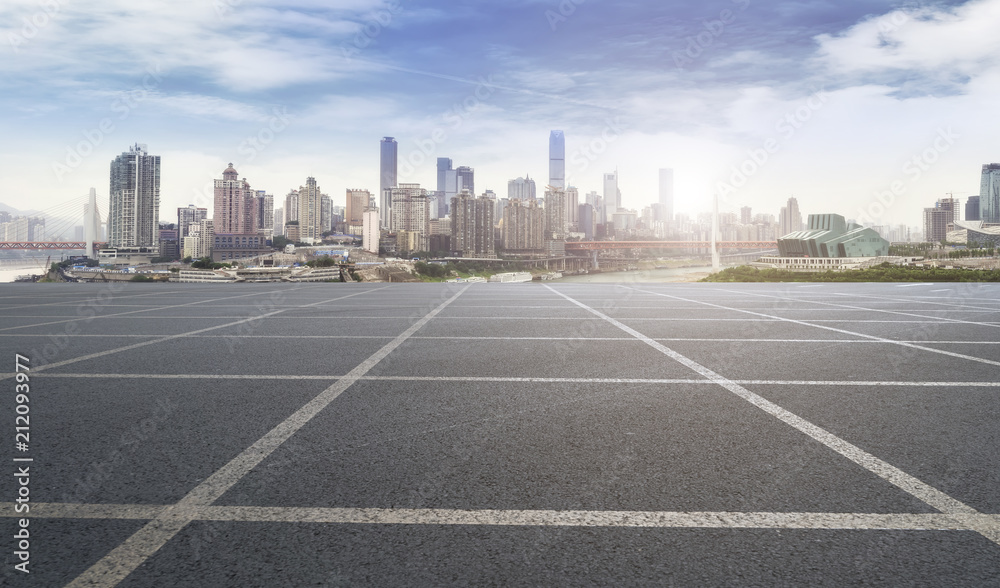 The empty asphalt road is built along modern commercial buildings in Chinas cities.