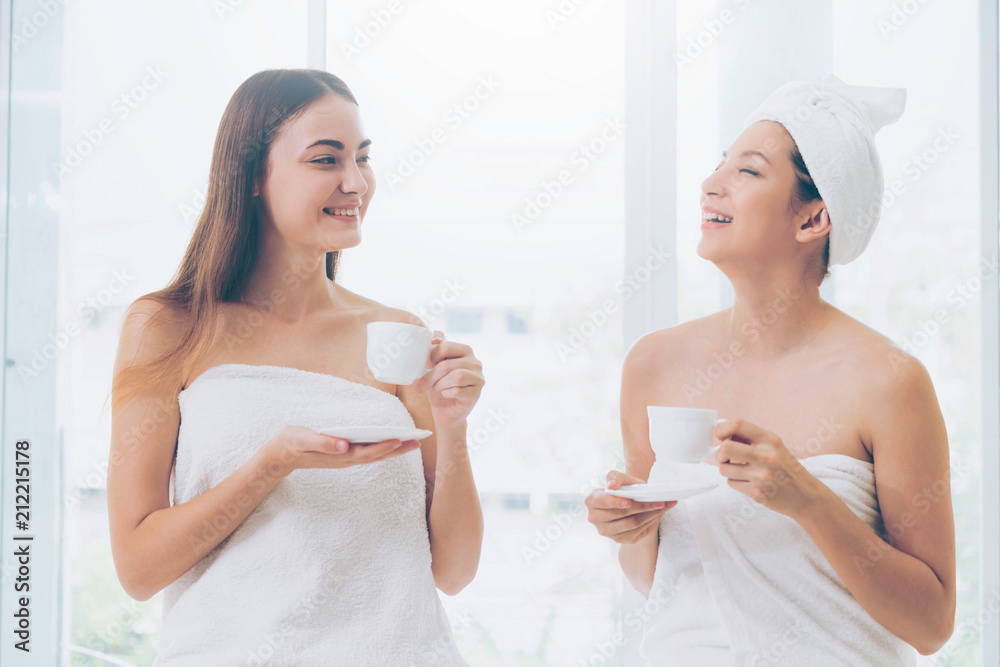 Two women drinking tea in luxury day spa.