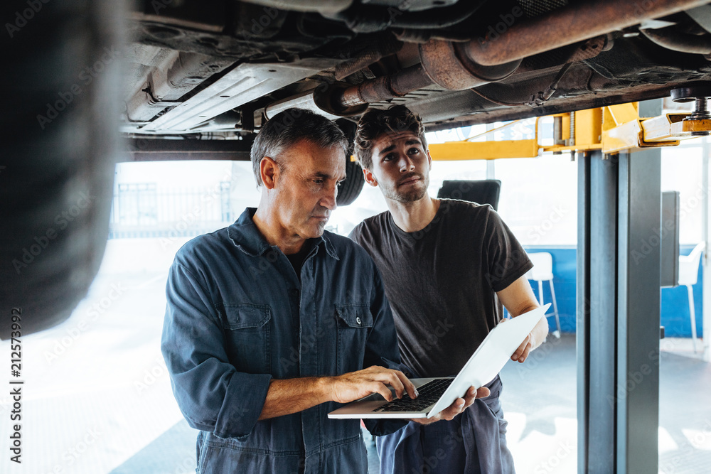 Technicians working in auto service station