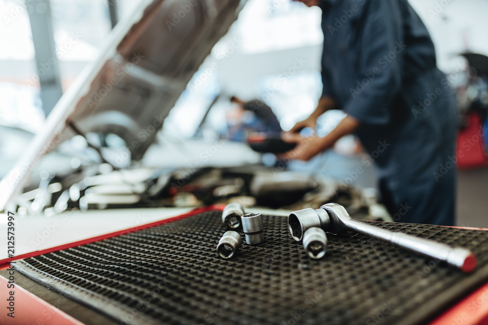 Ratchet spanner and sockets in car workshop