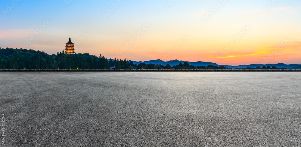 Asphalt road and hills silhouette at sunset in hangzhou