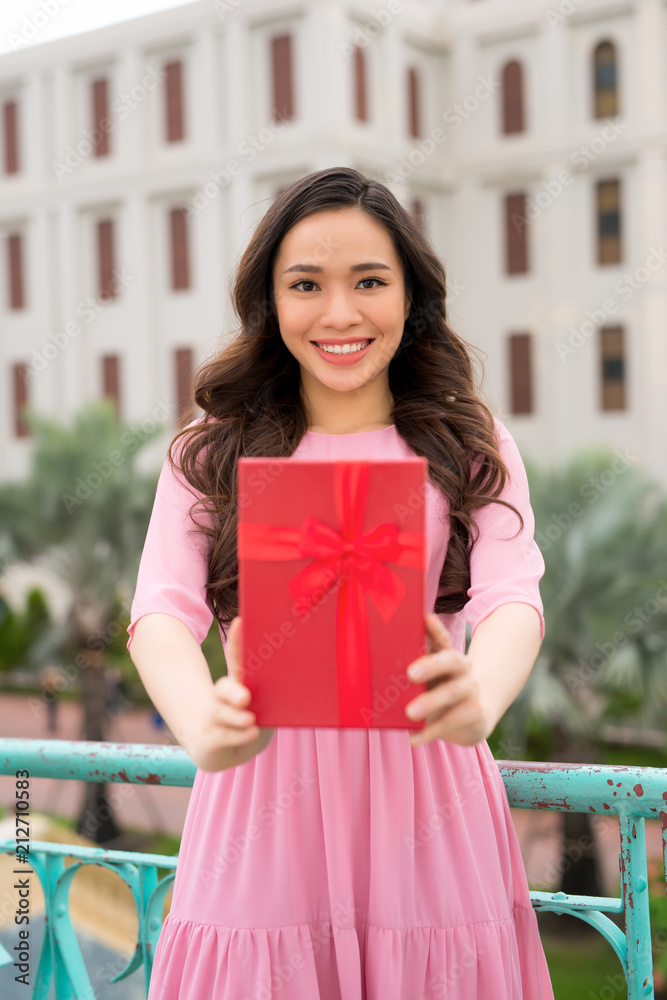 Charming beautiful woman hold red gift box , present box.