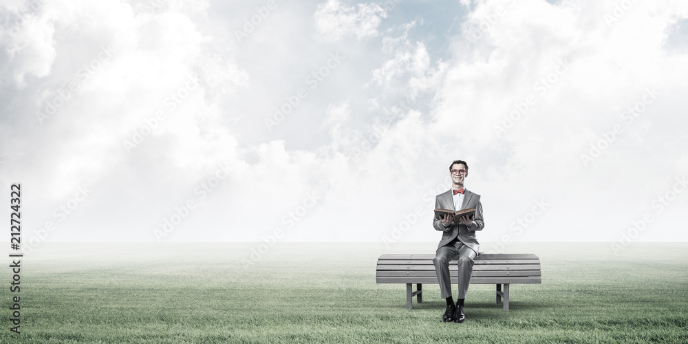 Young businessman or student studying the science in summer park