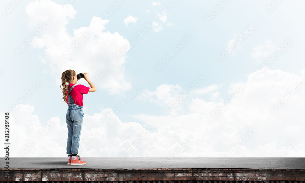 Concept of careless happy childhood with girl of school age looking in future