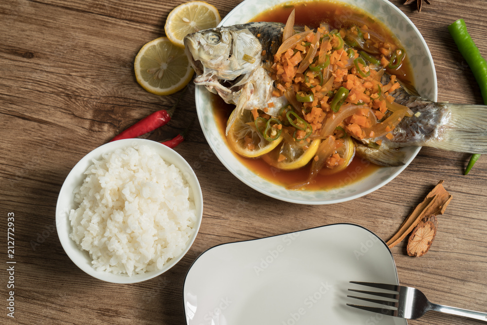 Lemon fish and wood grain background