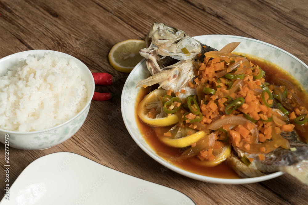 Lemon fish and wood grain background