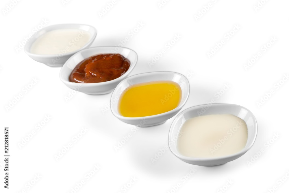 the various barbecue sauces in ceramic bowls