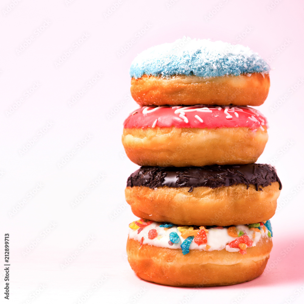 Delicious donuts for birthday on pastel pink background.