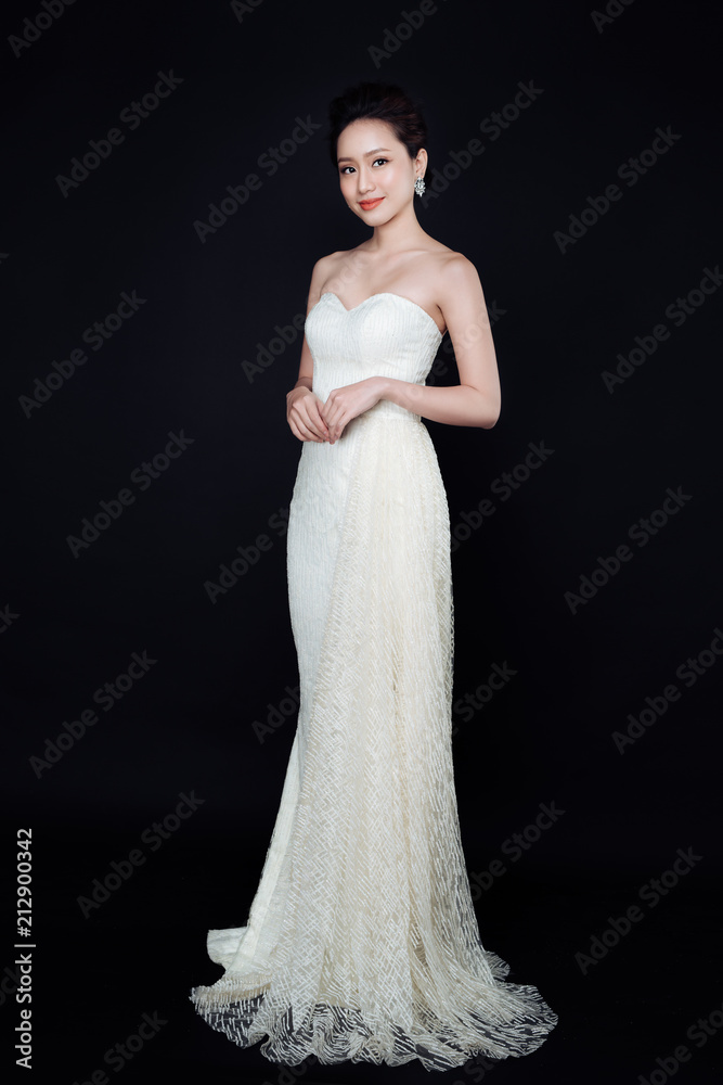 Beautiful woman portrait on black background. Young lady posing with gorgeous make up and hairstyle.