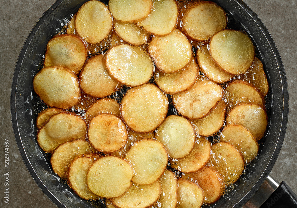 frying potatoes in pan with oil