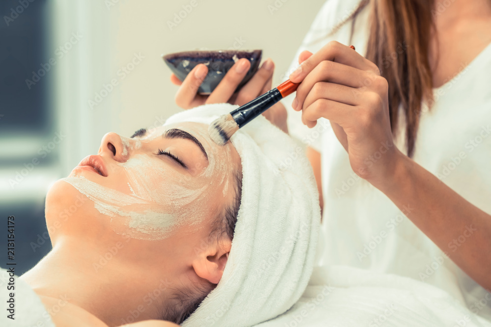 Beautiful woman having a facial treatment at spa.