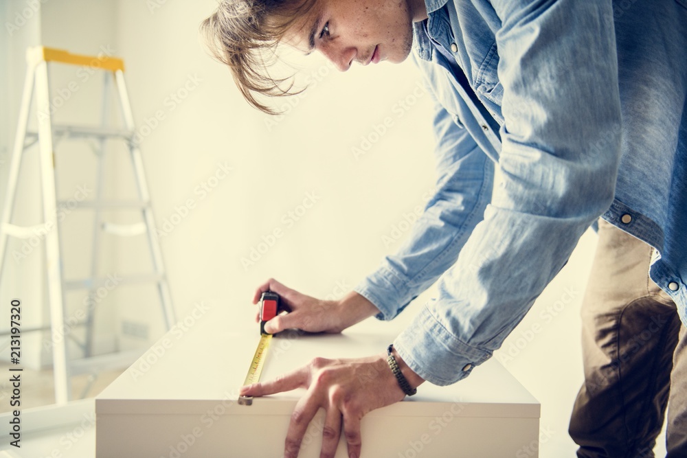 Man measuring the cabinet