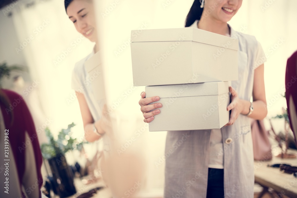 Woman carrying boxes of shoes