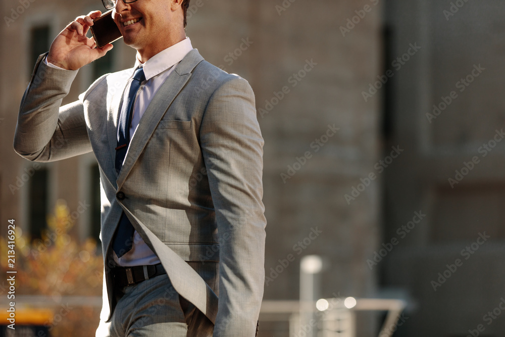 Businessman using mobile phone while commuting to office