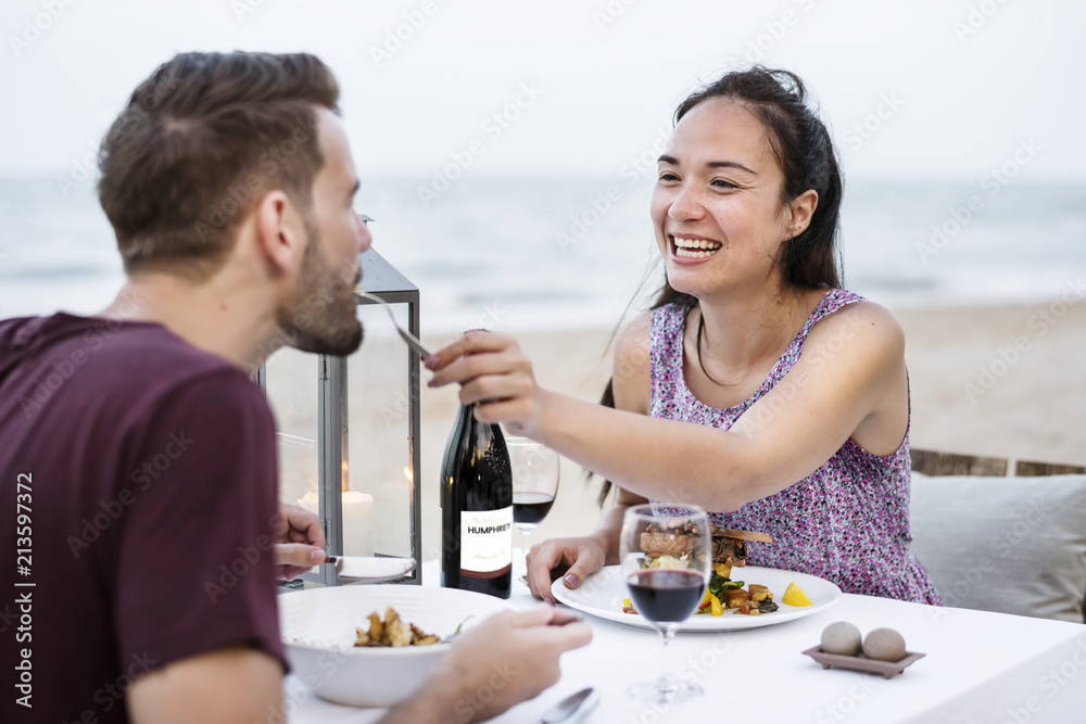 Couple enjoying a romantic dinner at the beach