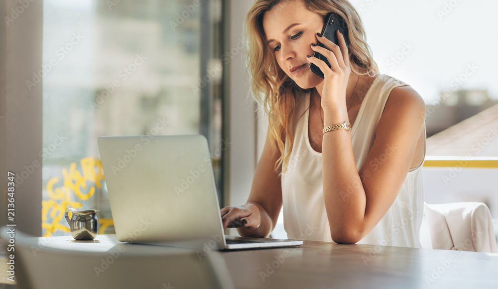 Young business woman working at cafe