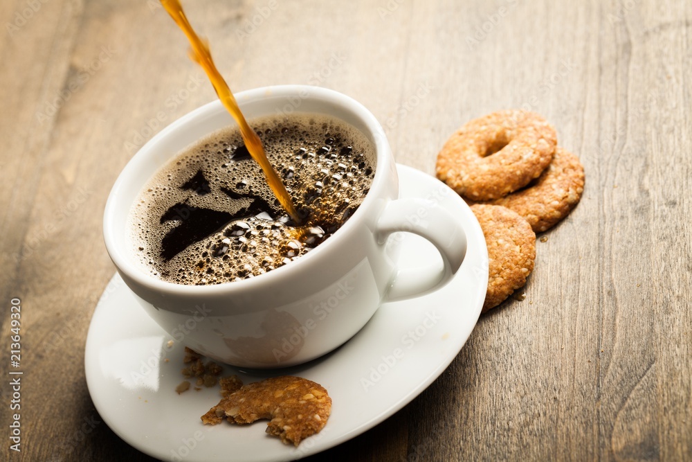 Coffee and oatmeal cookies on wooden table