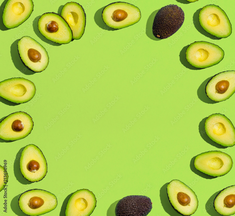 Fresh avocado pattern on a green background flat lay