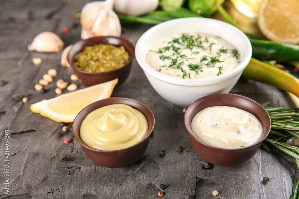 Bowls with different sauces on table