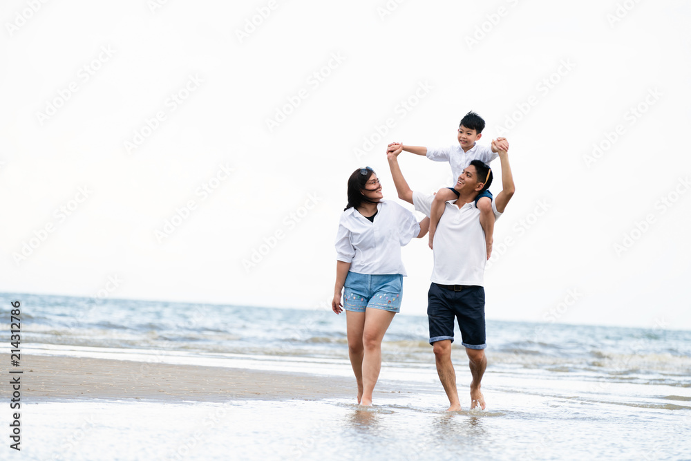 Happy family goes vacation on the beach in summer.