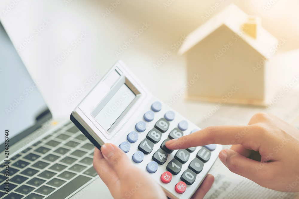 Woman accountant or bank worker uses calculator.