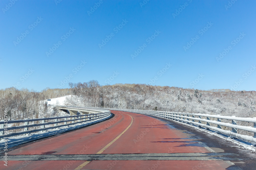 empty asphalt road with city skyline