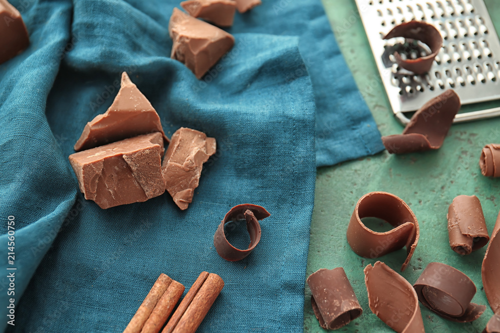 Napkin with delicious chocolate pieces and curls on table