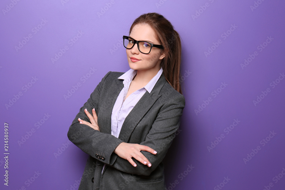 Young woman in formal clothes on color background