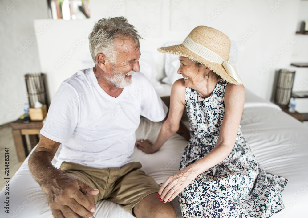 Couple smiling at each other on the bed