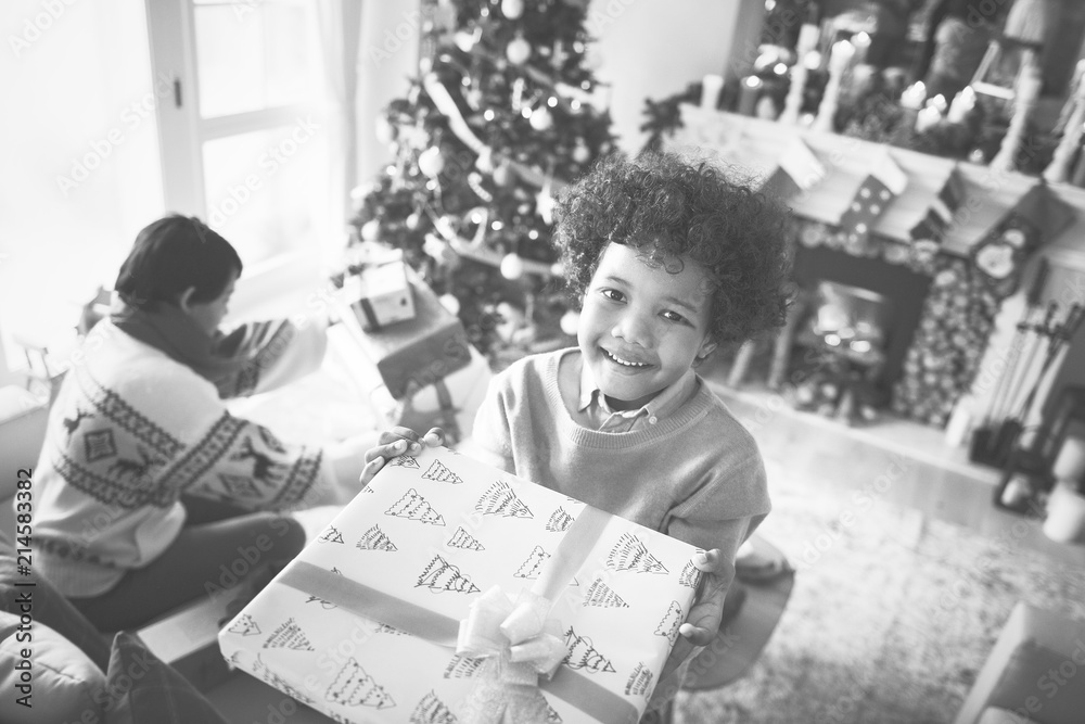 African kid holding a Christmas present