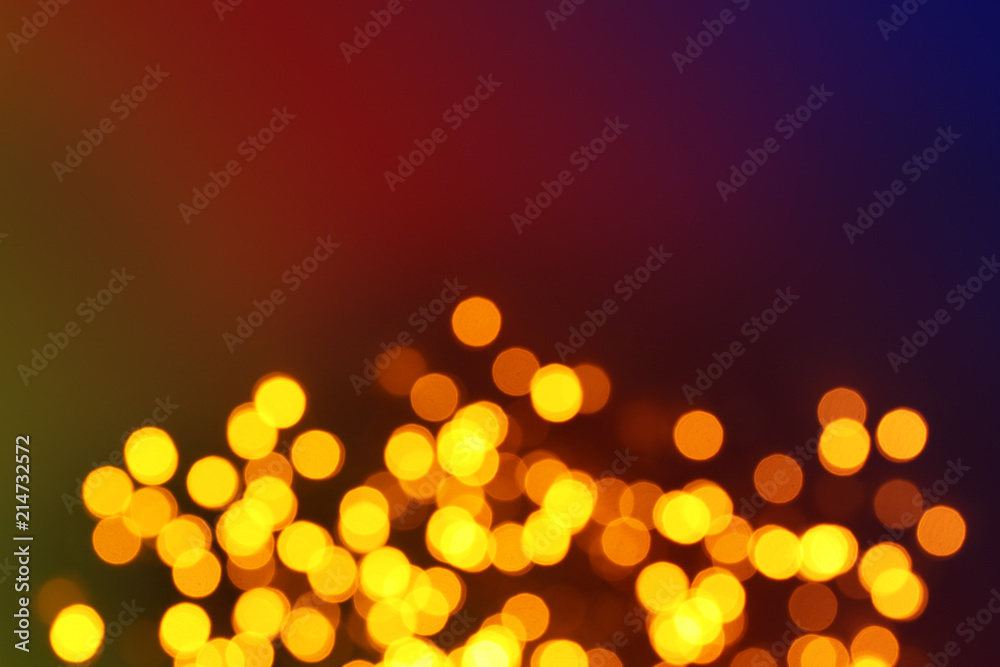 Glowing Christmas lights on dark background, blurred view