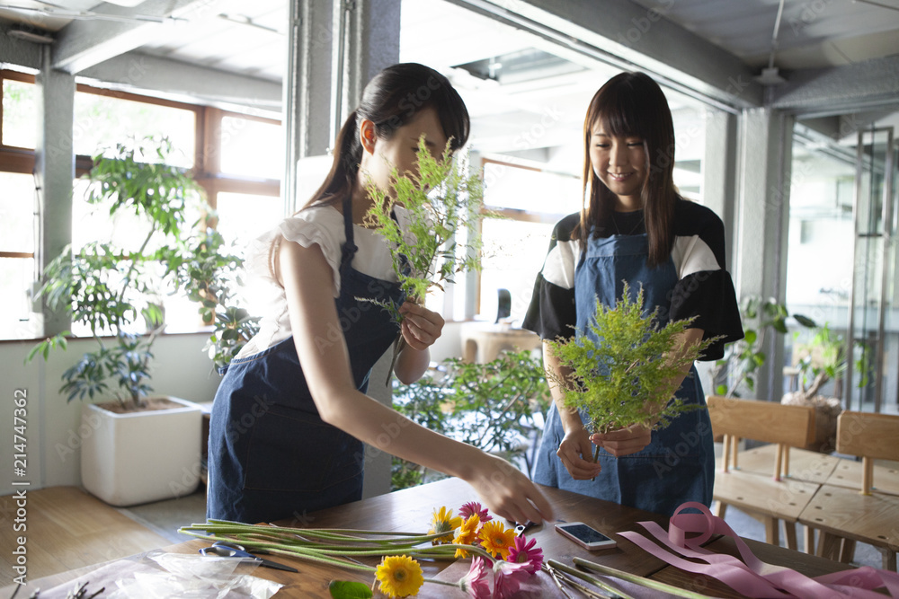 花屋で花束の作り方を教える店員