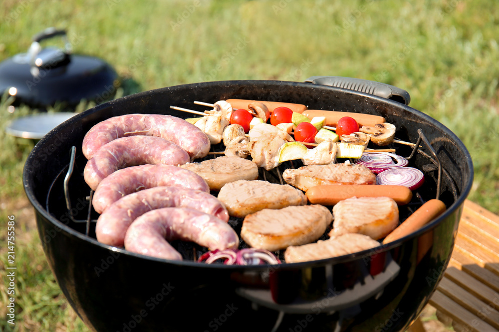 Meat and vegetables on modern grill outdoors