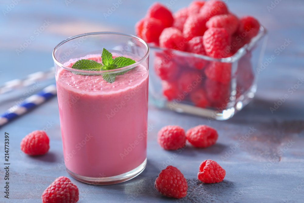 Glass with tasty raspberry smoothie on wooden table