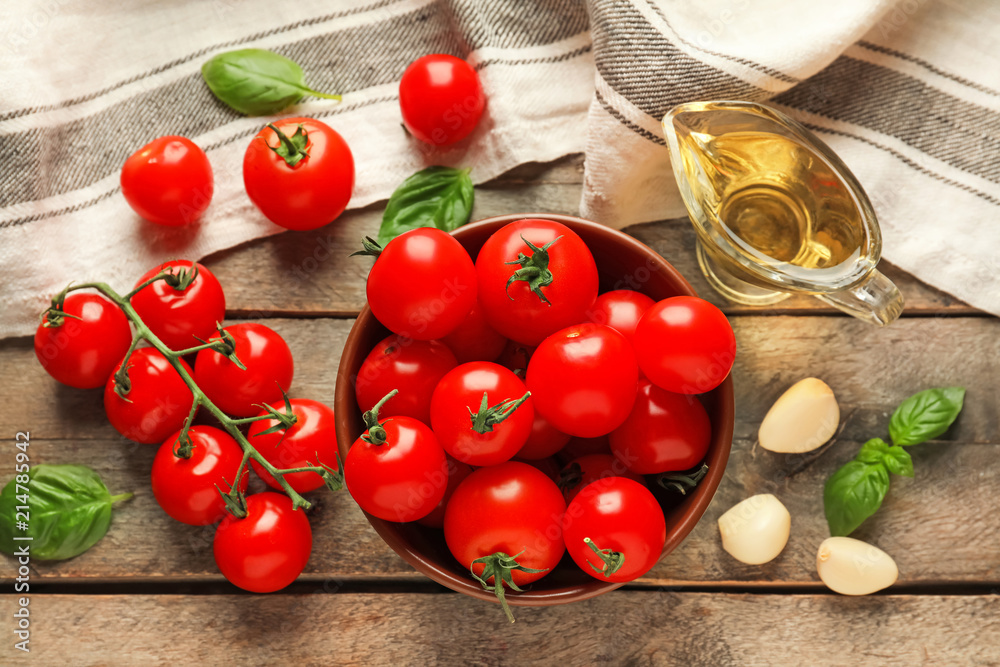 Composition with fresh cherry tomatoes on wooden table