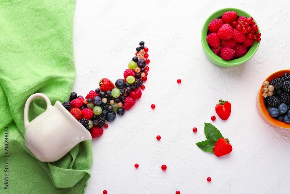 Composition with delicious ripe berries on light background